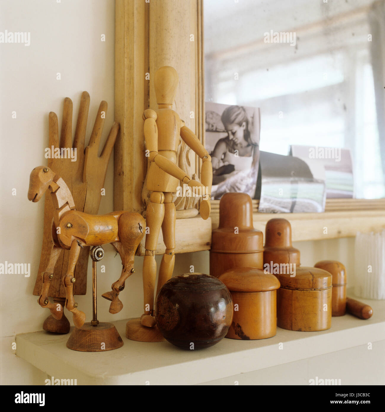 Wooden figurines on mantelpiece. Stock Photo