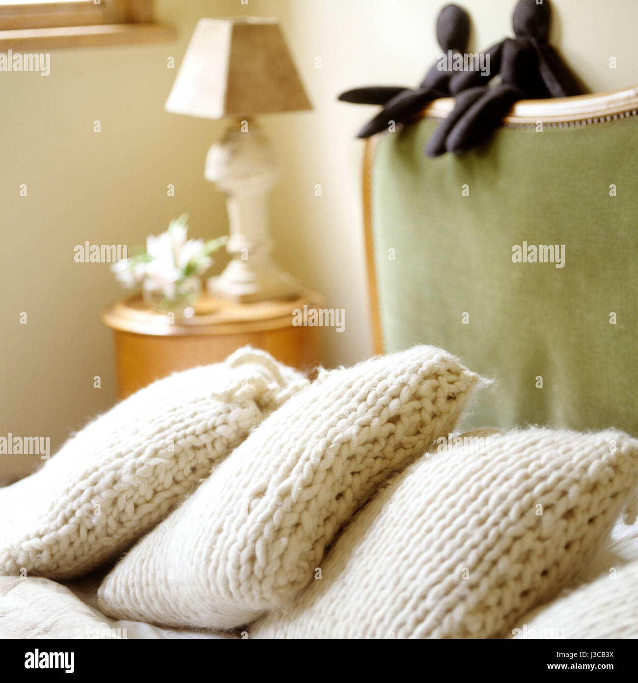 Knitted pillows with dolls. Stock Photo