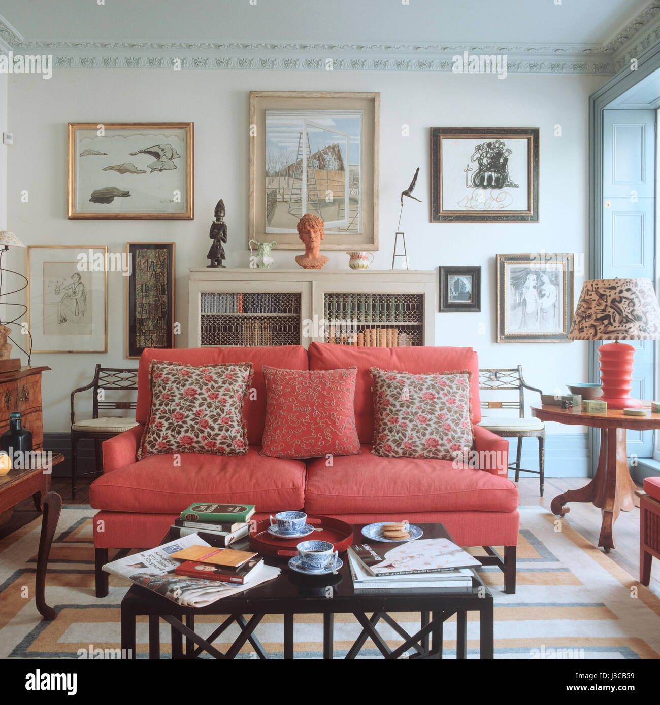 Real Photo Of A Pink Couch With Pillows Standing Next To Big