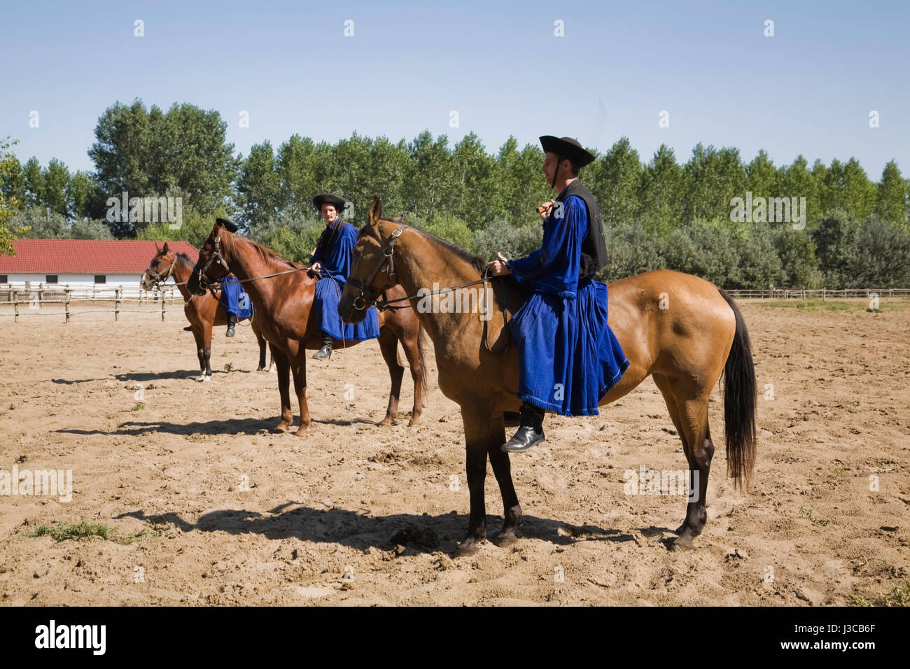 Chicos in traditional blue costume at a horse farm in the Puszta region of Hungary, Europe. Stock Photo