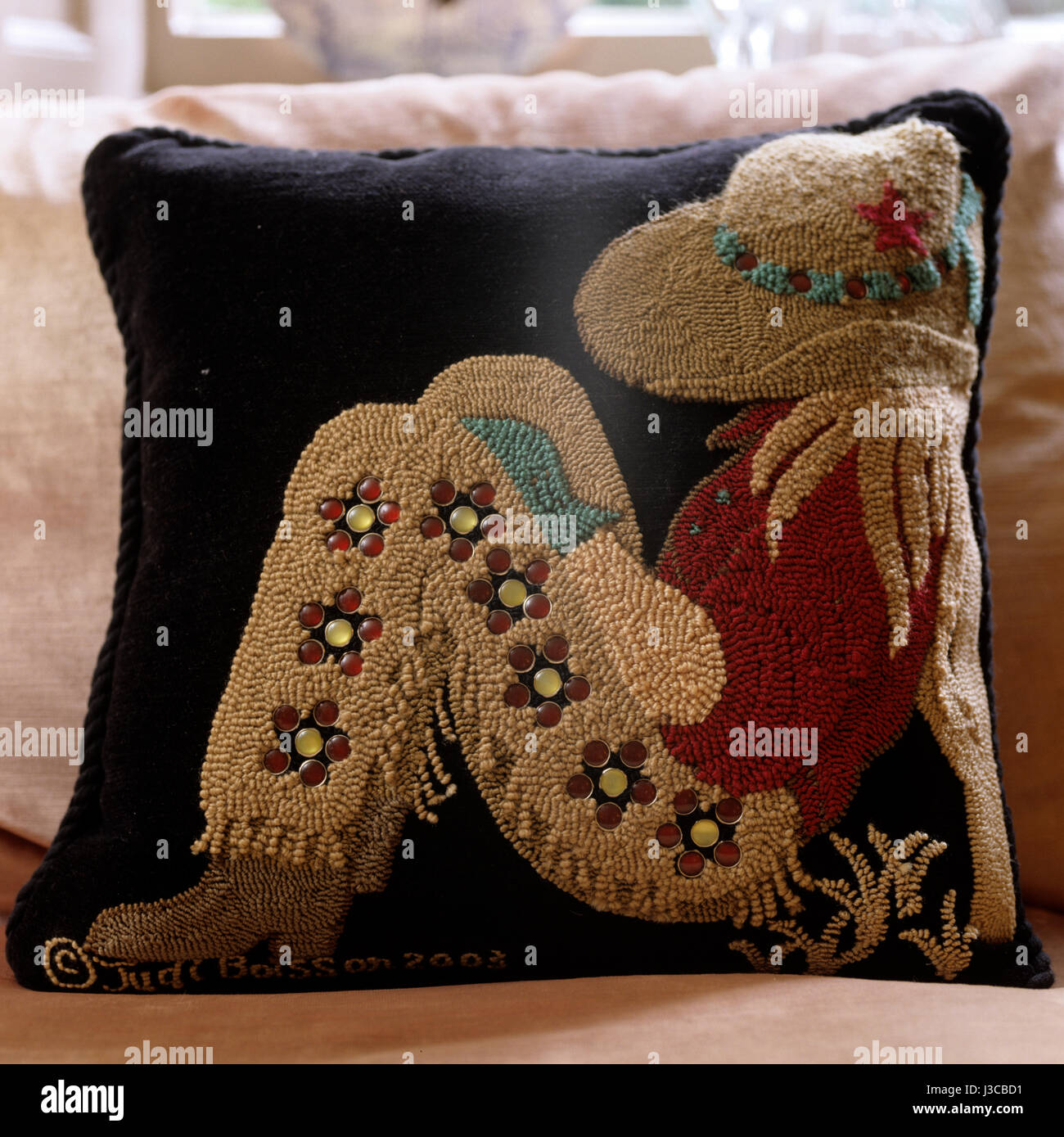 A Judi Boisson cushion cover of a sleeping cowgirl Stock Photo