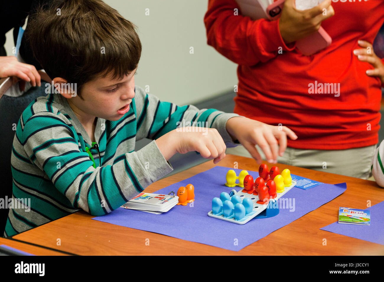 Boy playing Balance Beans board game - USA Stock Photo