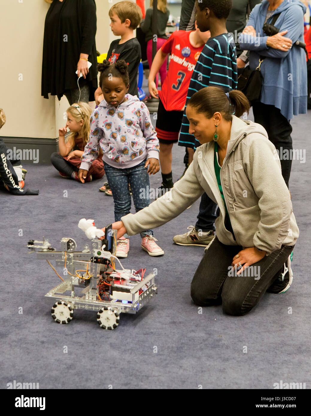 Children watching robotics demonstration during STEM festival - USA Stock Photo