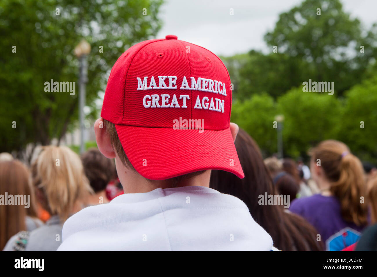 Young Caucasian Trump supporter wearing 'Make America Great Again' hat ( MAGA hat ) - USA Stock Photo