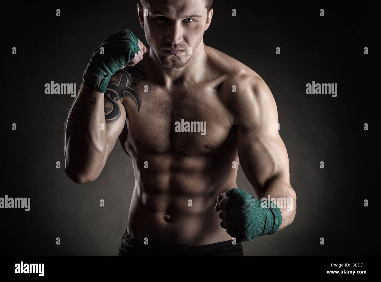 Boxing man ready to fight. Boxer with strong hands and clenched fists