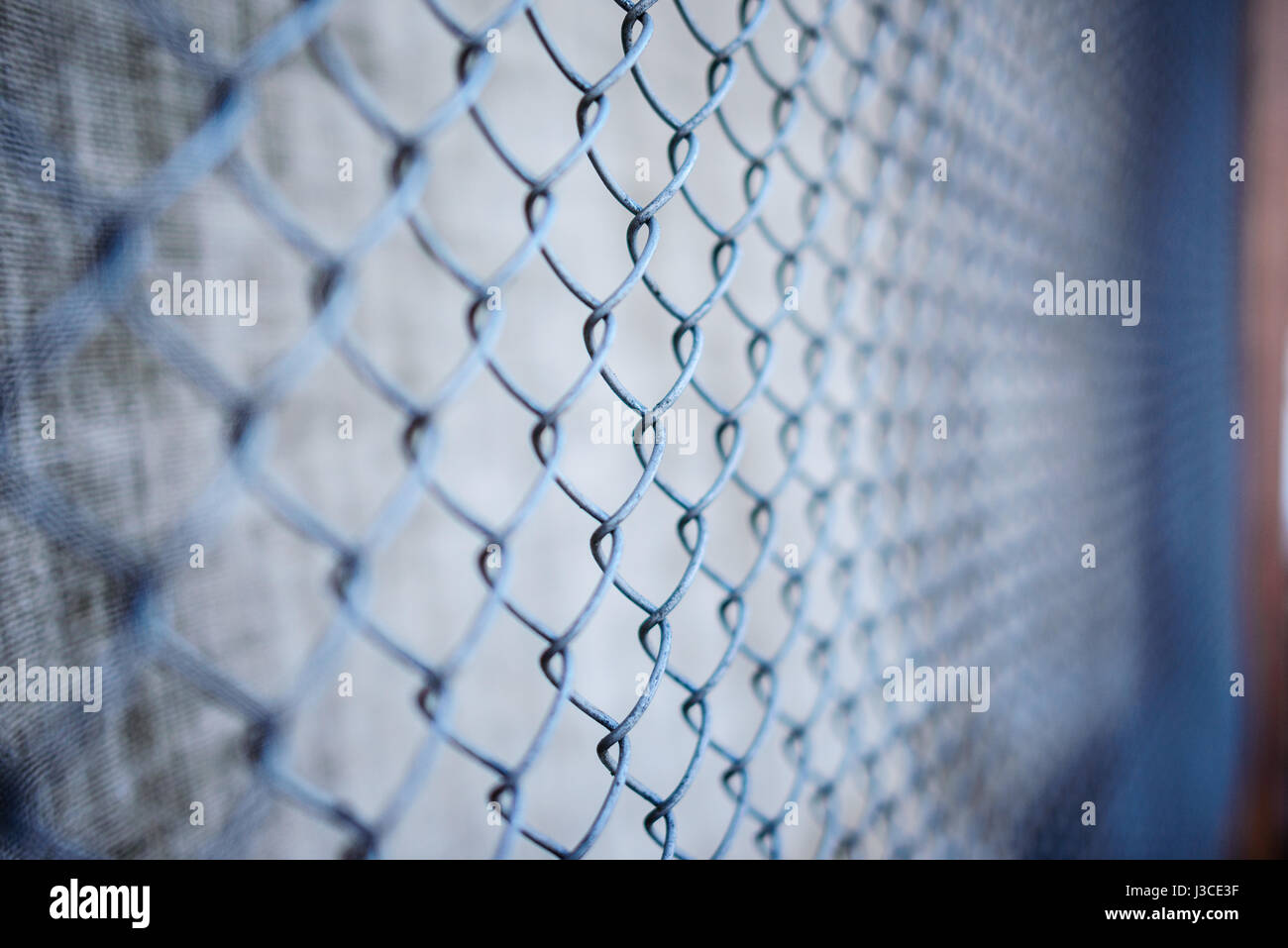 fence with metal grid in perspective, background Stock Photo - Alamy