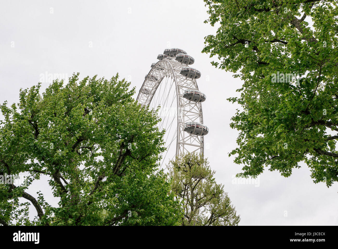 A merry-go-round and the London Eye ferris wheel on Southbank in London, one of the city's most popular areas. Stock Photo