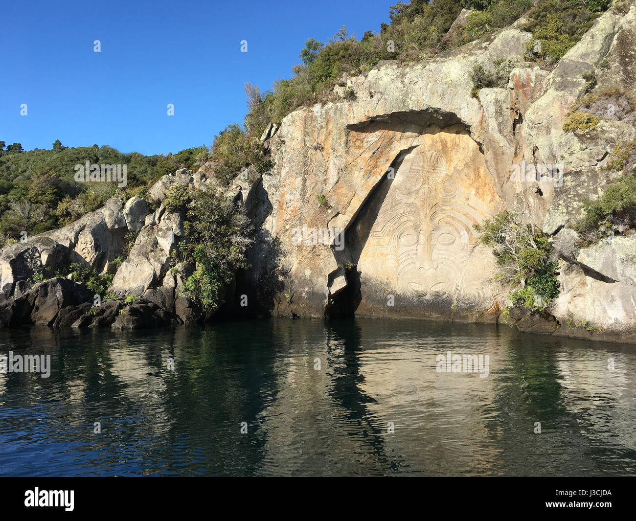 Maori Rock Carving at lake Taupo in the North Island of New Zealand Stock Photo