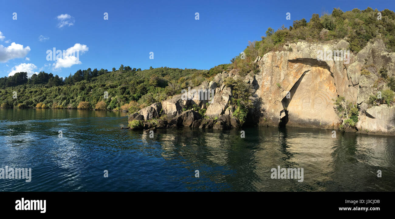Panoramic landscape view of the Maori Rock Carving at lake Taupo in the North Island of New Zealand Stock Photo