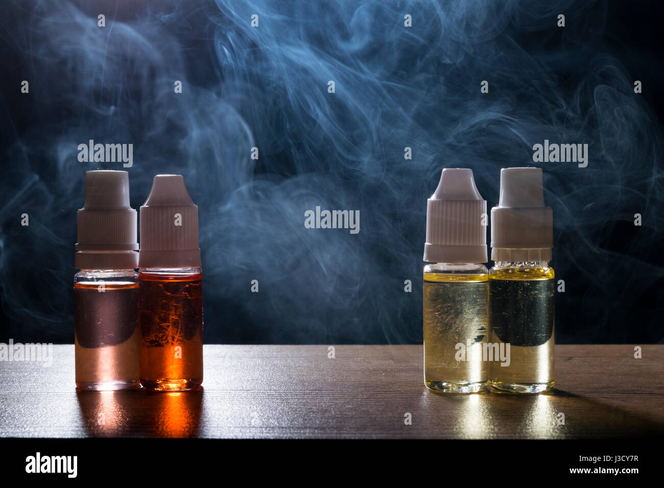 electronic cigarette e liquid isolated vape e liquid for electronic cigarette on a dark background Stock  Photo