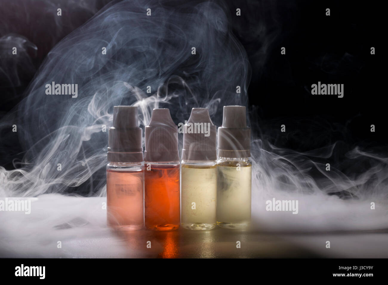 isolated vaping e liquid for electronic cigarette on smoking background. Stock Photo