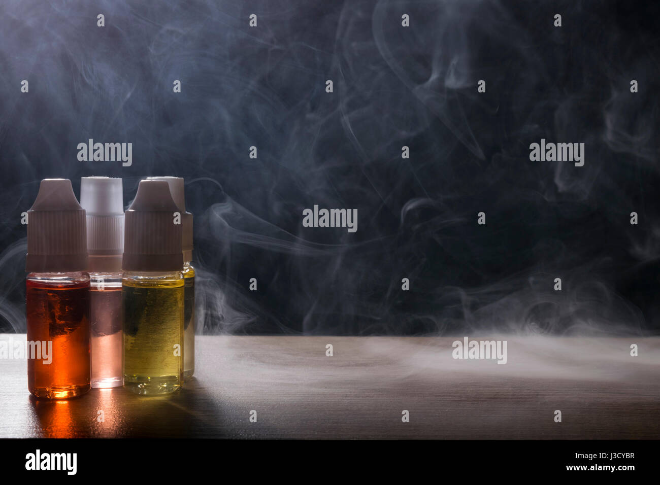 isolated vape e liquid  for electronic cigarette with lots of smoke cloads. Stock Photo