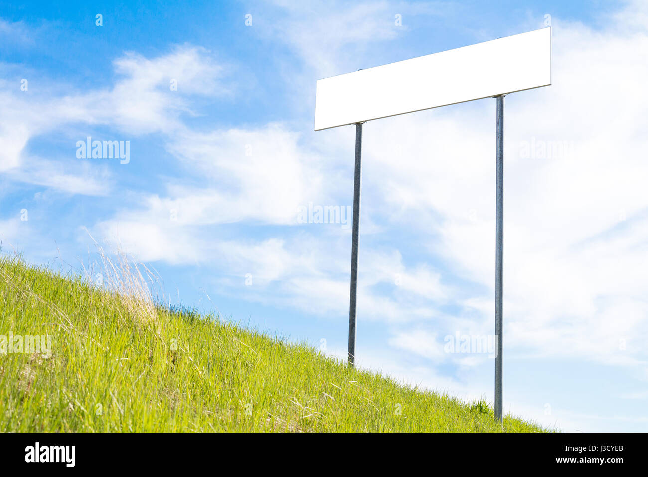 Blank sign board on a background of green grass and blue sky Stock ...