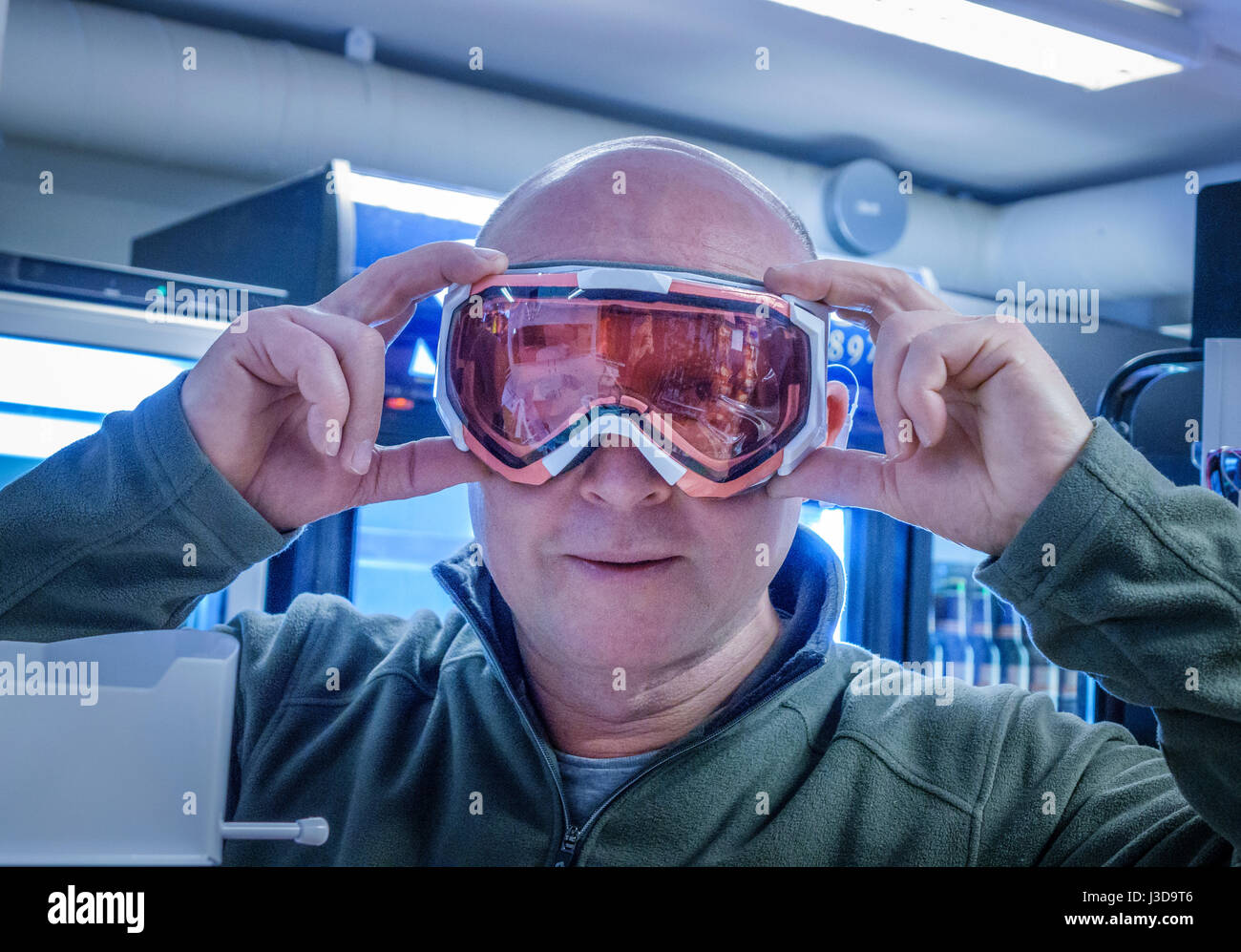 Man shopping for ski googles Stock Photo