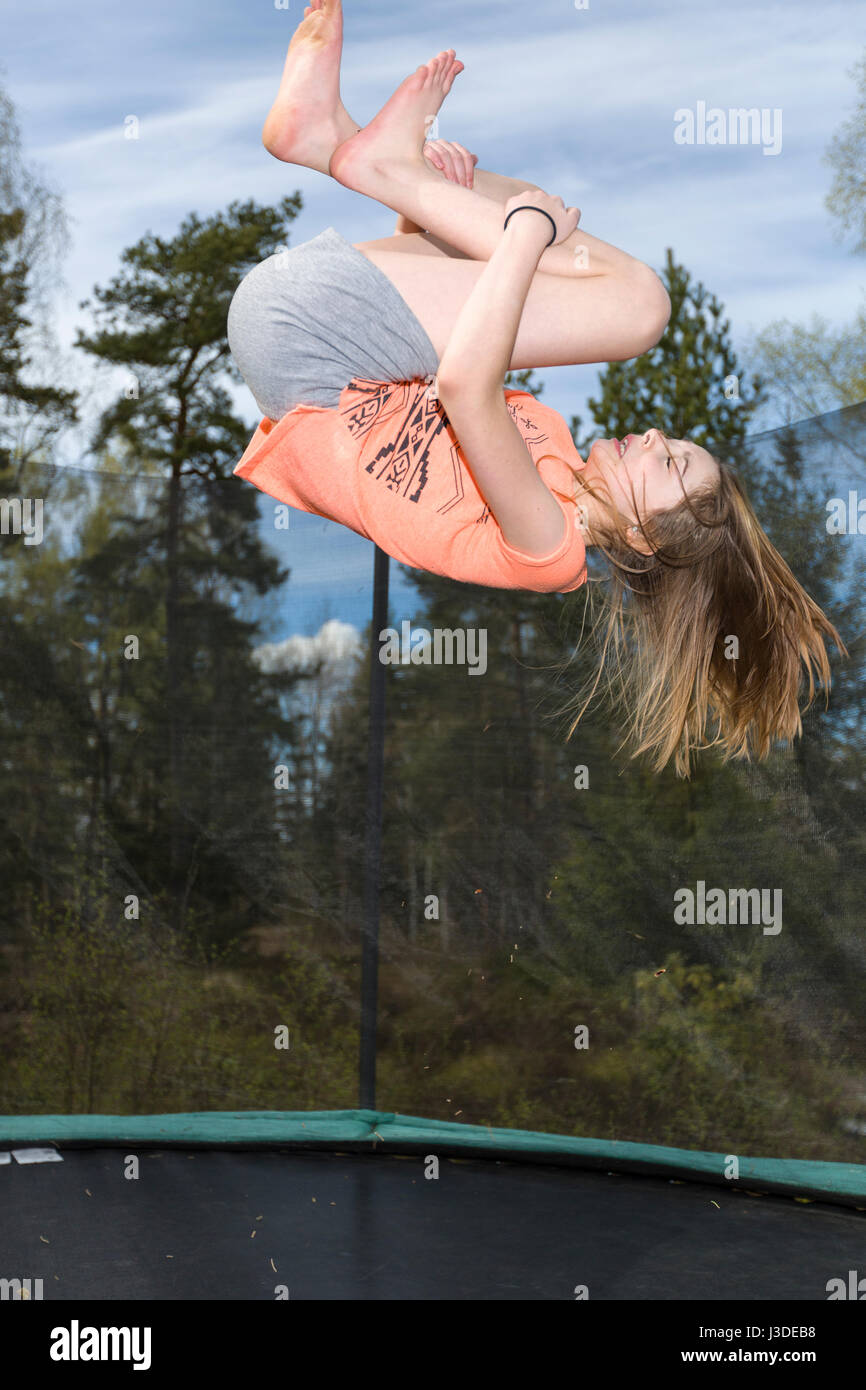 Young Girl Jumping On Trampoline High Resolution Stock Photography and