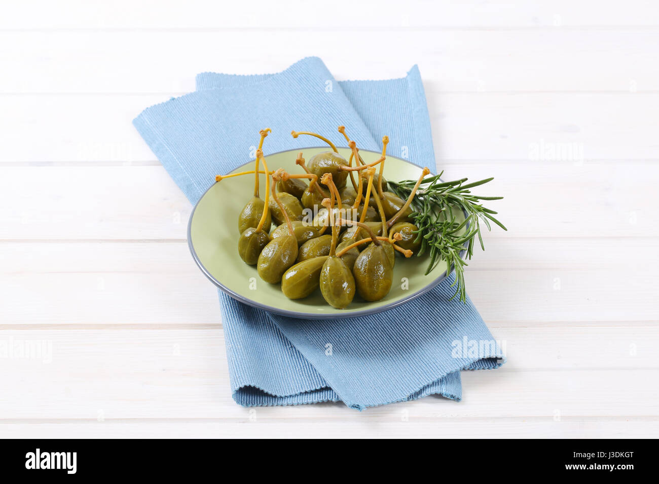 plate of pickled caper berries with stems on Stock Photo Alamy