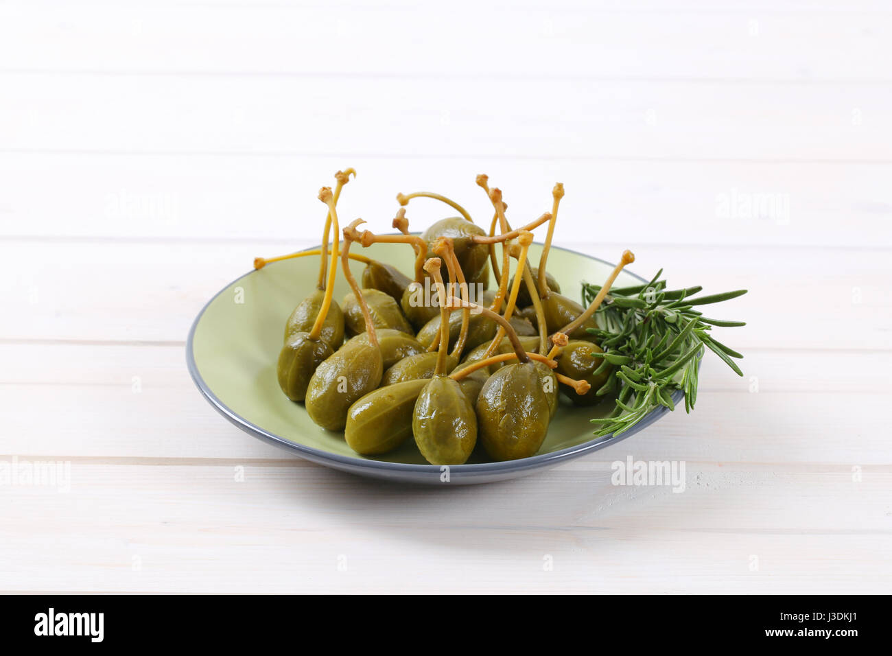 plate of pickled caper berries with stems on Stock Photo Alamy