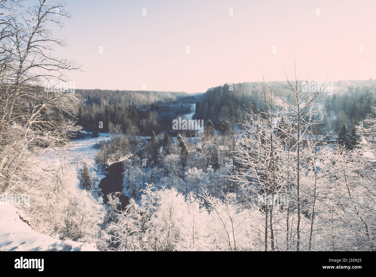 snowy winter landscape with snow covered trees and blue sky - retro ...