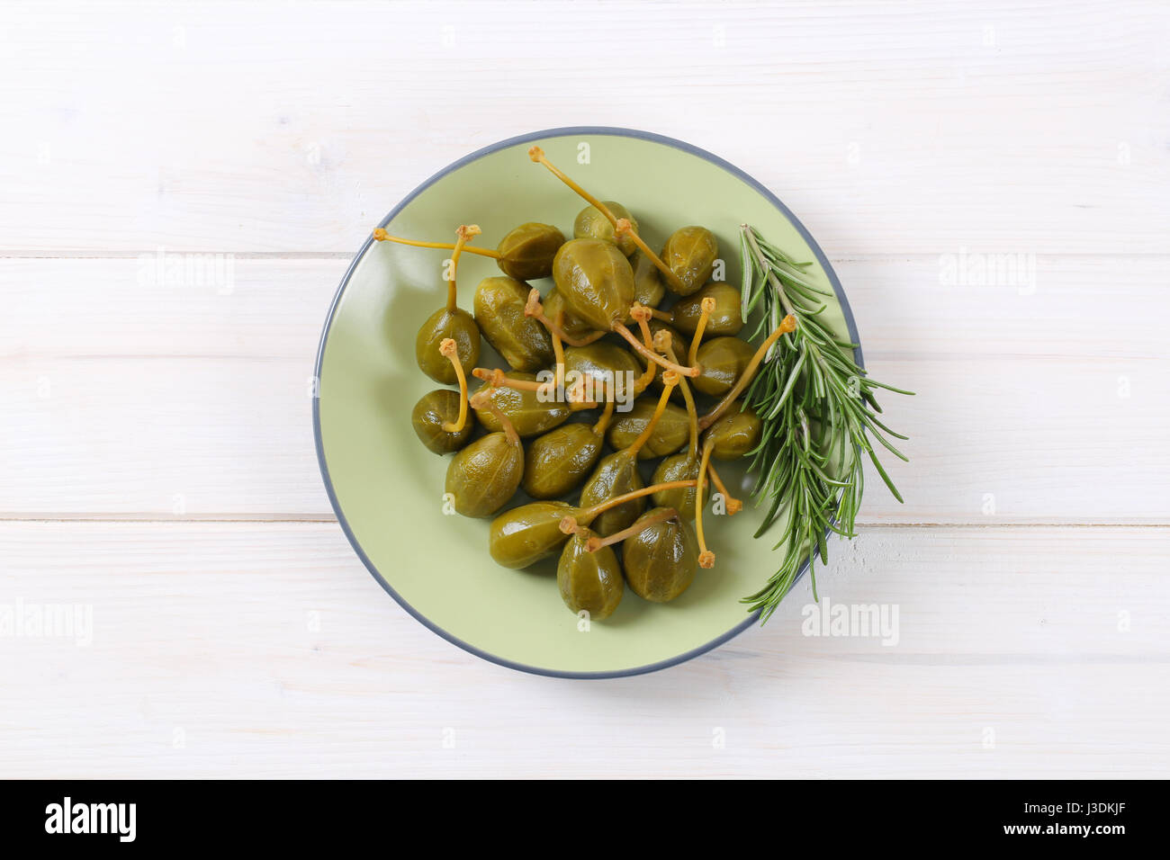 plate of pickled caper berries with stems on Stock Photo Alamy