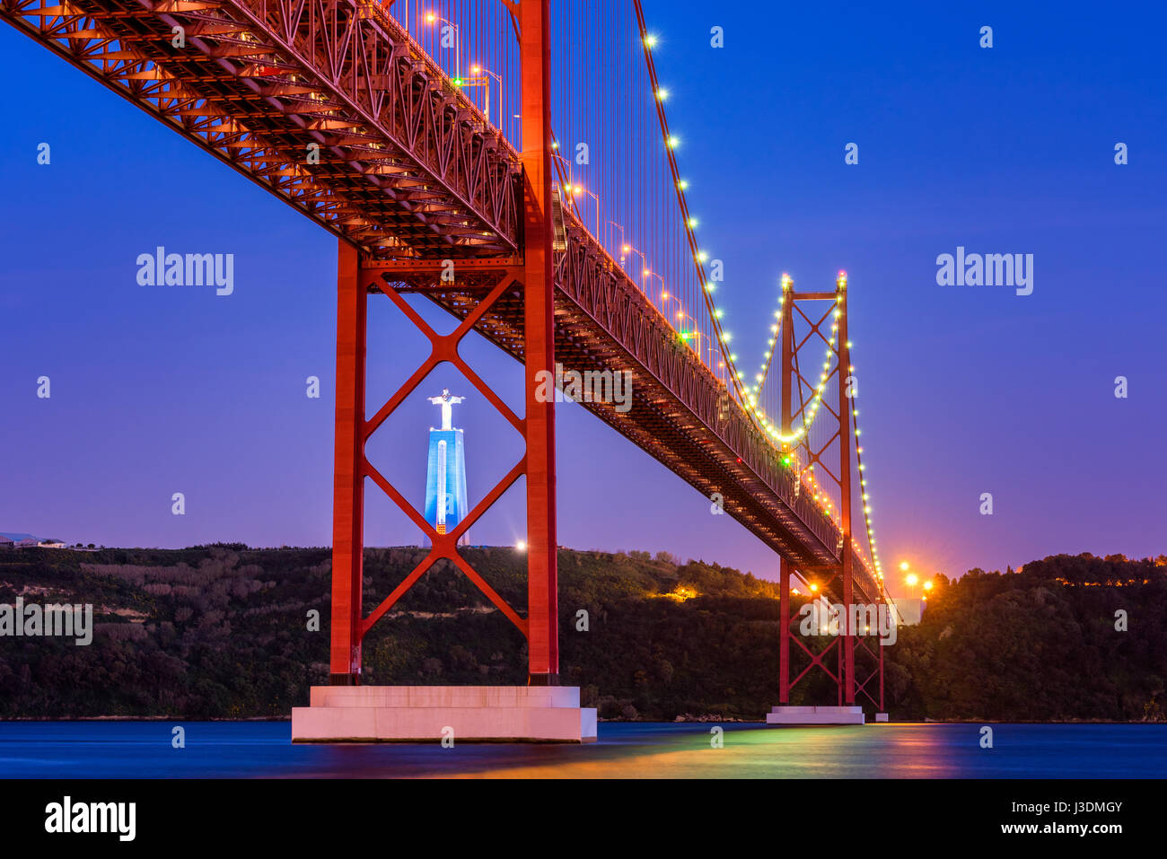 April 25th Bridge, Tagus River and Christ the King statue in Lisbon Portugal around sunset Stock Photo