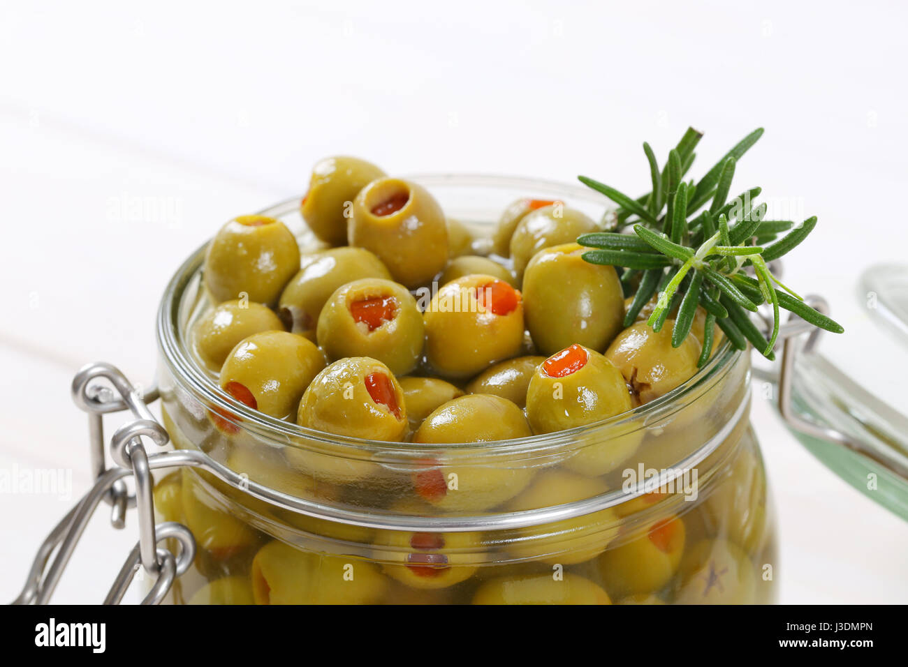 jar of green olives stuffed with red pepper close up Stock Photo Alamy