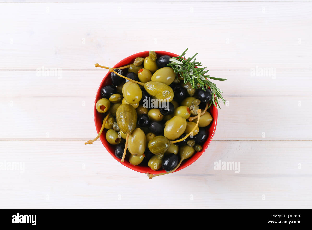 bowl of pickled olives, capers and caper berries Stock Photo Alamy