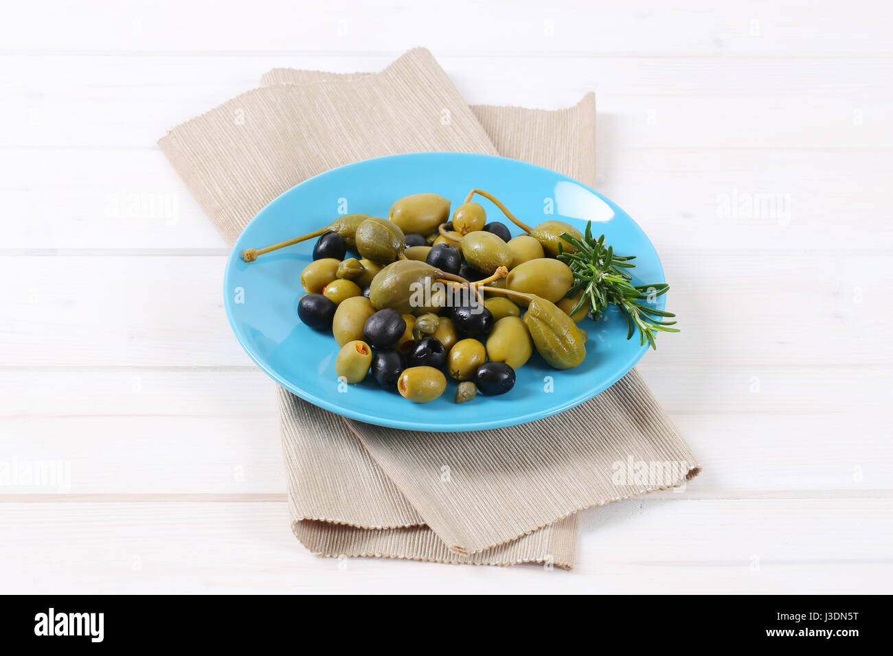plate of pickled olives, capers and caper berries Stock Photo Alamy