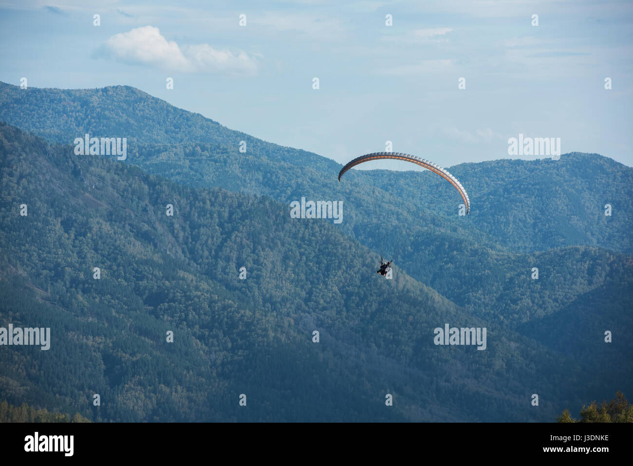 Paragliding in mountains. Para gliders in fight in the mountains, extreme sport activity. Stock Photo