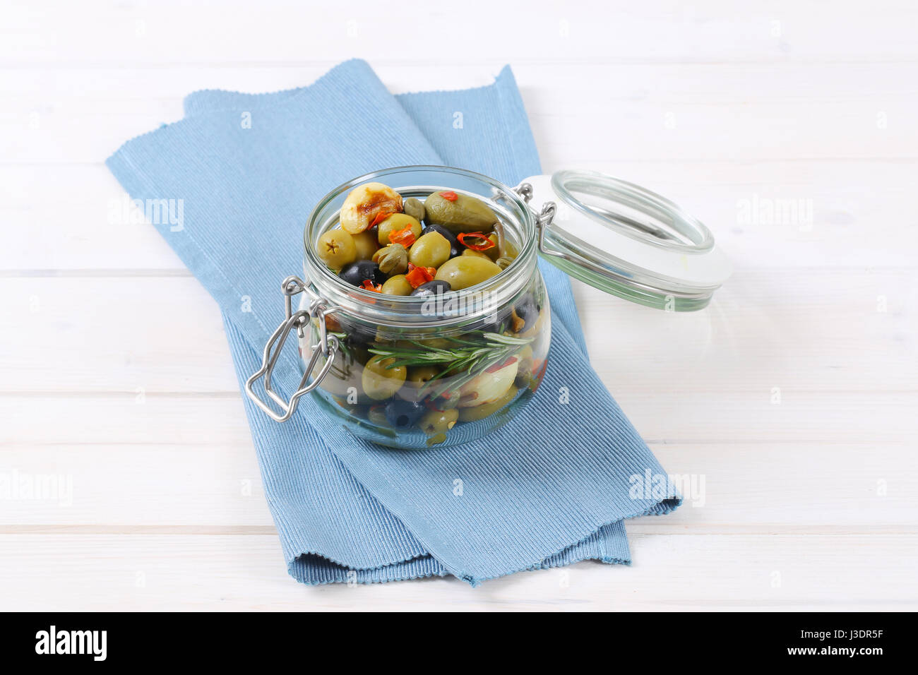 jar of pickled olives, capers, caper berries and garlic Stock Photo Alamy