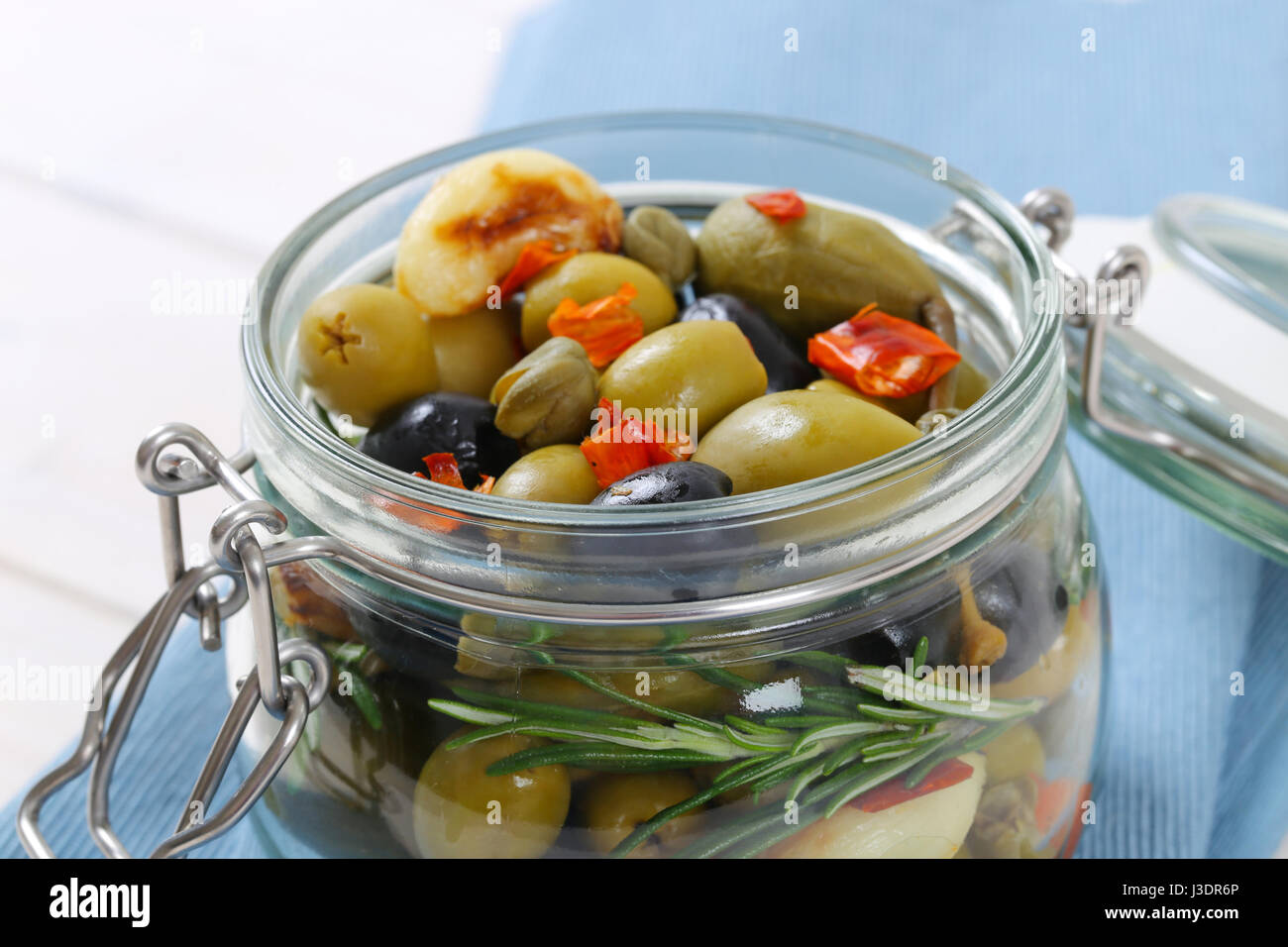 jar of pickled olives, capers, caper berries and garlic Stock Photo Alamy