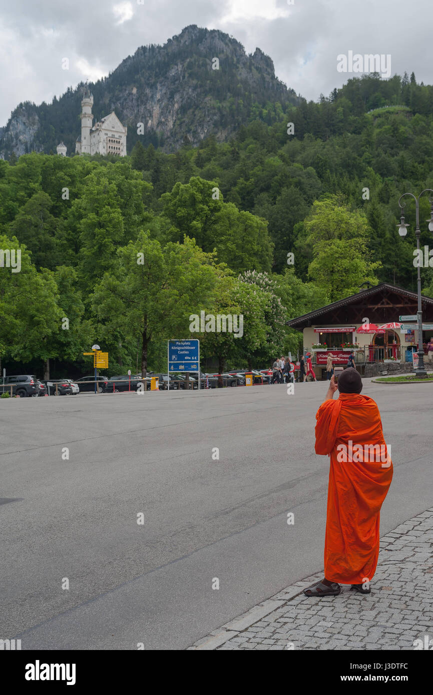 GERMANY. Bavaria. 2016. A  Buddhist monk at Neuschwanstein Castle Stock Photo