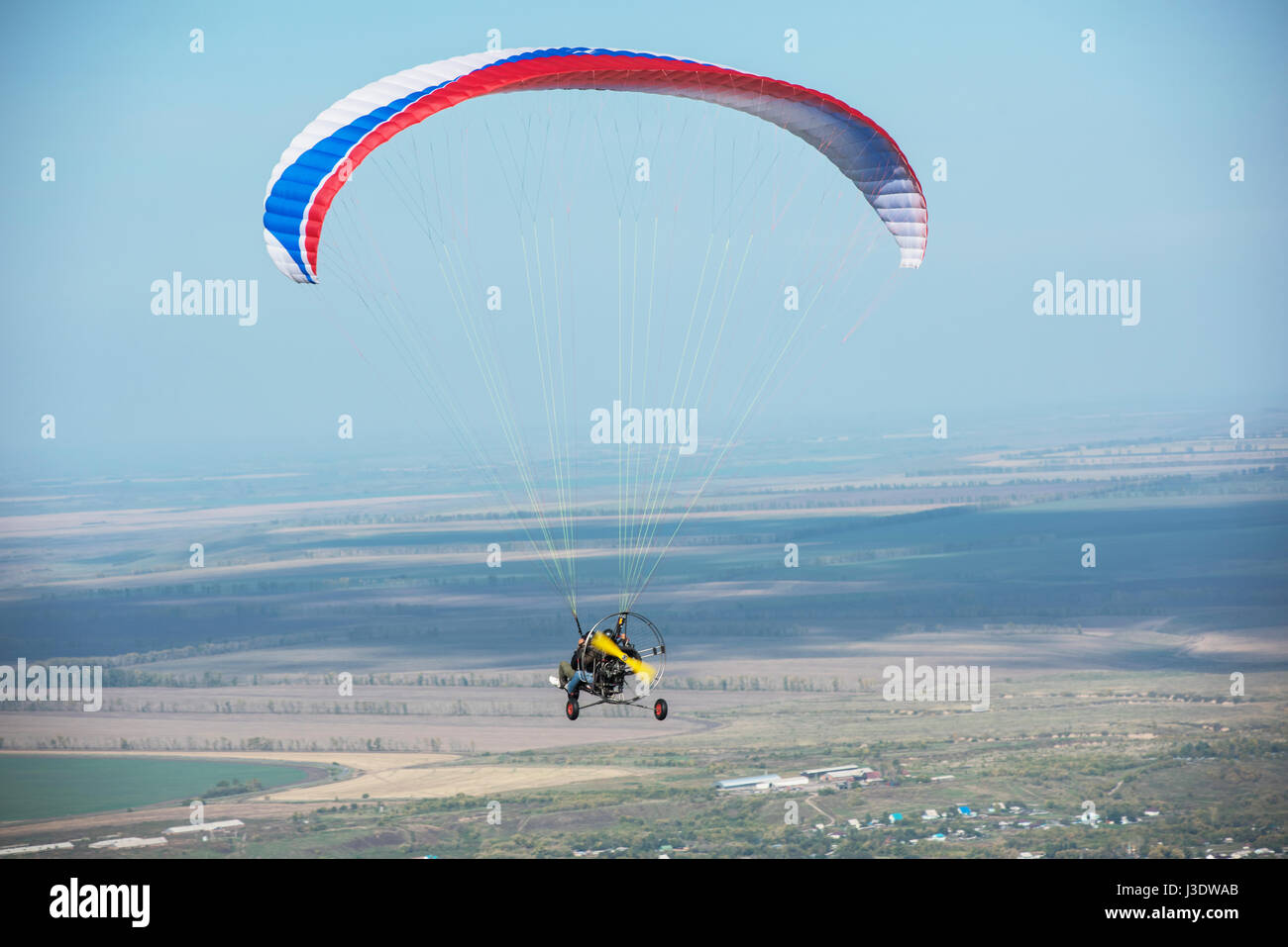 Paragliding in mountains. Para gliders in fight in the mountains, extreme sport activity. Stock Photo
