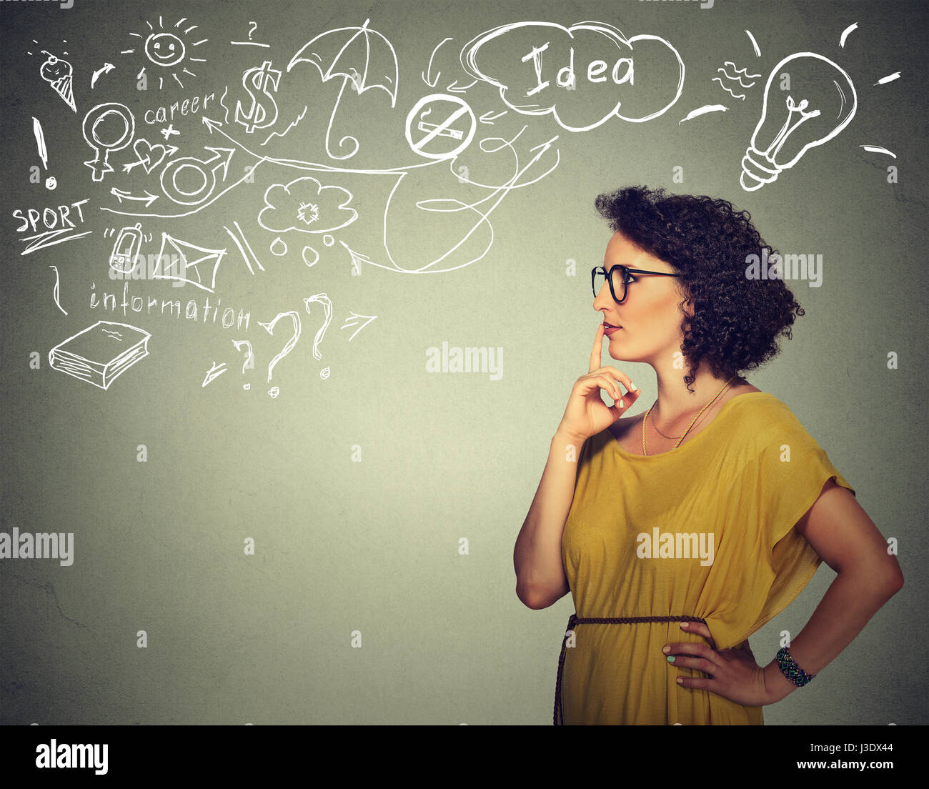 Portrait happy young woman thinking dreaming has many ideas looking side way isolated grey background. Positive human face expression emotion feeling  Stock Photo