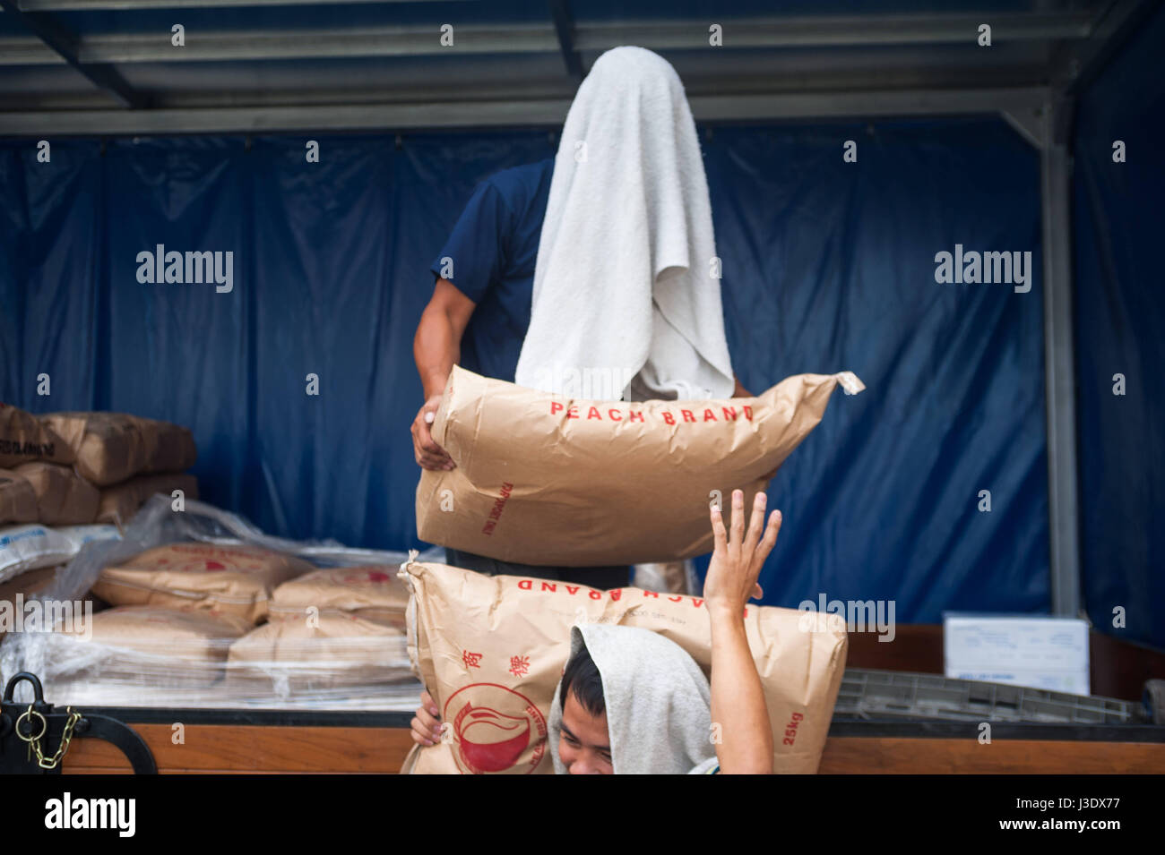 Singapore, Republic of Singapore, Asia, Workers unload flour sacks Stock Photo