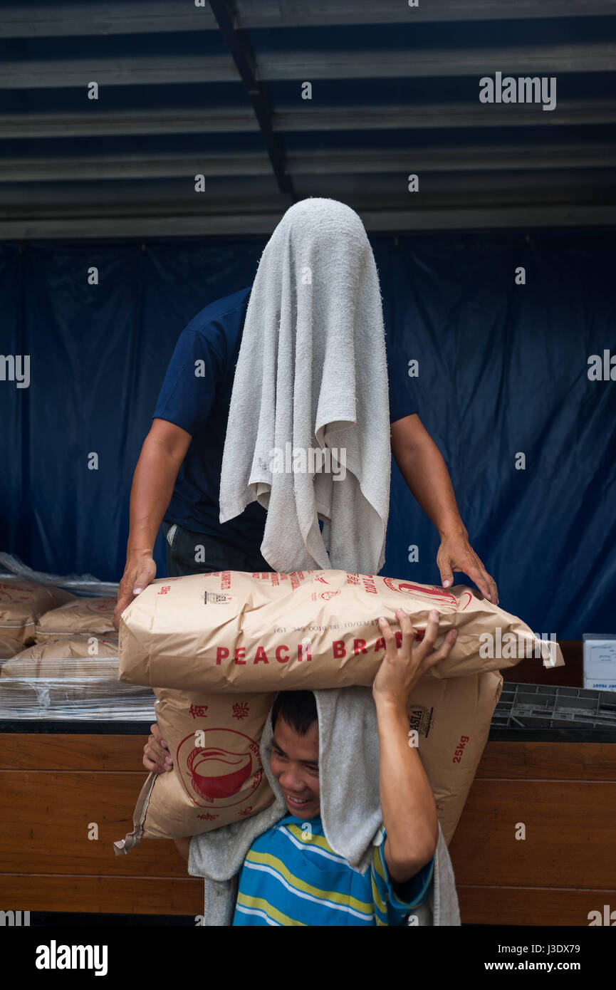 Singapore, Republic of Singapore, Asia, Workers unload flour sacks Stock Photo