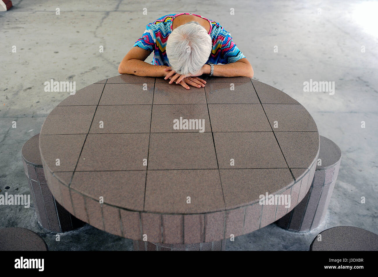 Singapore, Republic of Singapore, Asia, A woman rests at a table Stock Photo