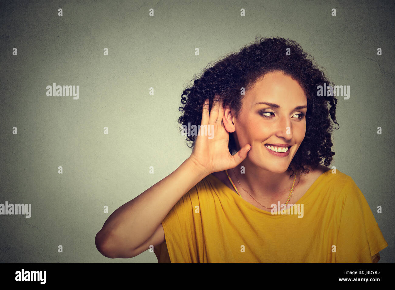 Closeup portrait happy middle aged nosy woman hand to ear gesture carefully secretly listening juicy gossip conversation privacy violation isolated on Stock Photo