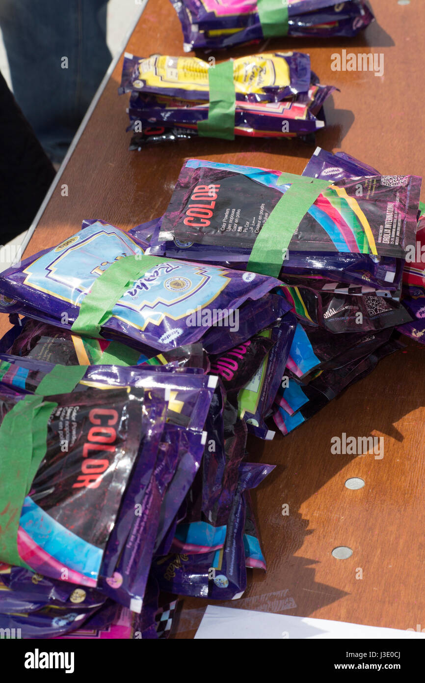 Packets of Colour Powder For Sale on Table at Holi 2017, London, Ontario, Canada in Victoria Park Stock Photo