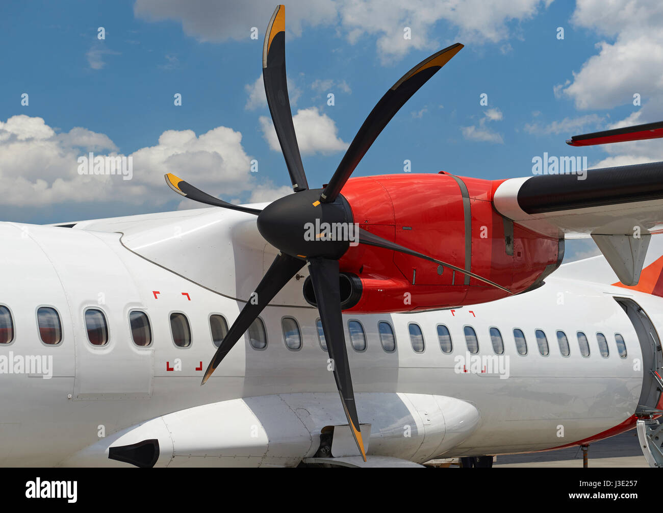 Propeller engine in modern plane close-up on sunny blue sky background Stock Photo