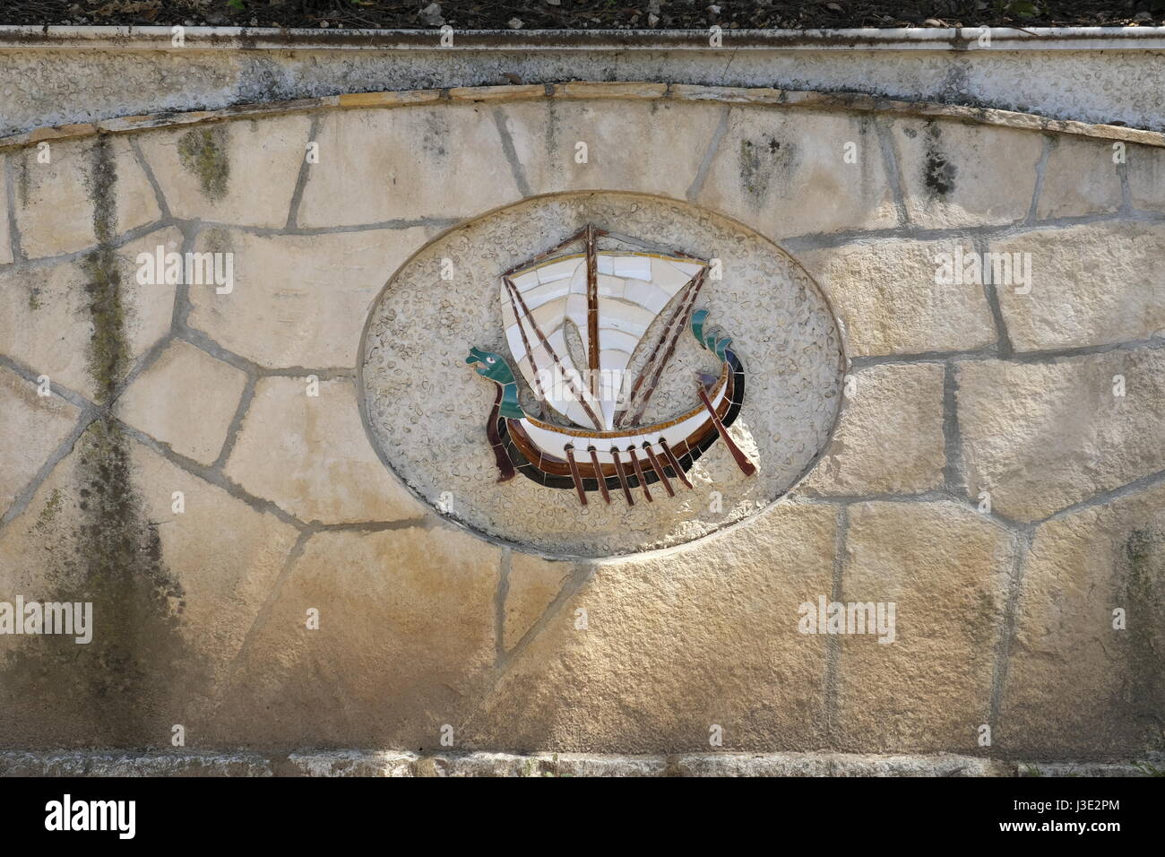 Nice, Provence-Alpes-Côte d'Azur, France. Modern mosaic of Viking ship in wall in Castle Hill Stock Photo