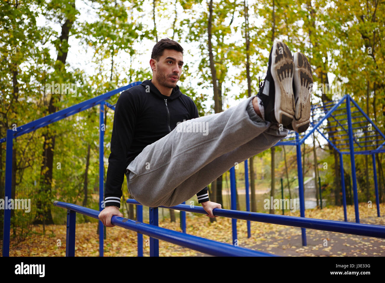 Doing Triceps Dips on Parallel Bars Stock Photo