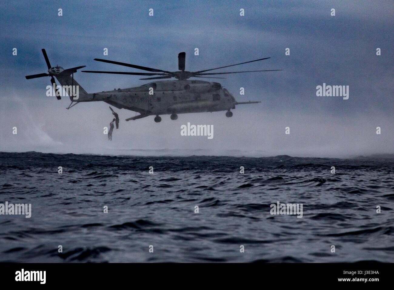 A USMC CH-53E Super Stallion helicopter releases U.S. Marine soldiers during a helocasting exercise March 19, 2017 in the Pacific Ocean.    (photo by Jona R. Meme/US Marines via Planetpix) Stock Photo