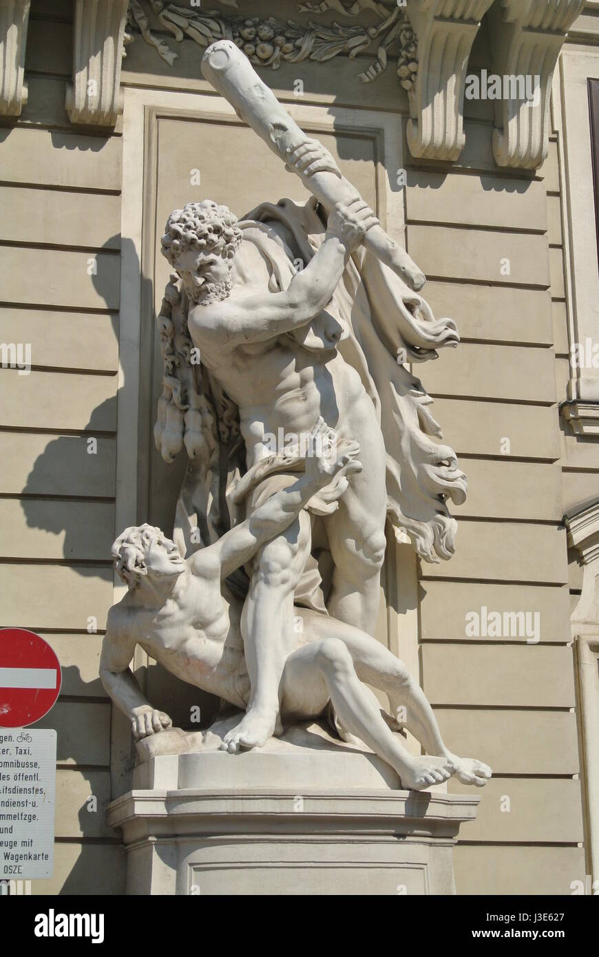 Classical style stone statue of Hercules with club beating another man