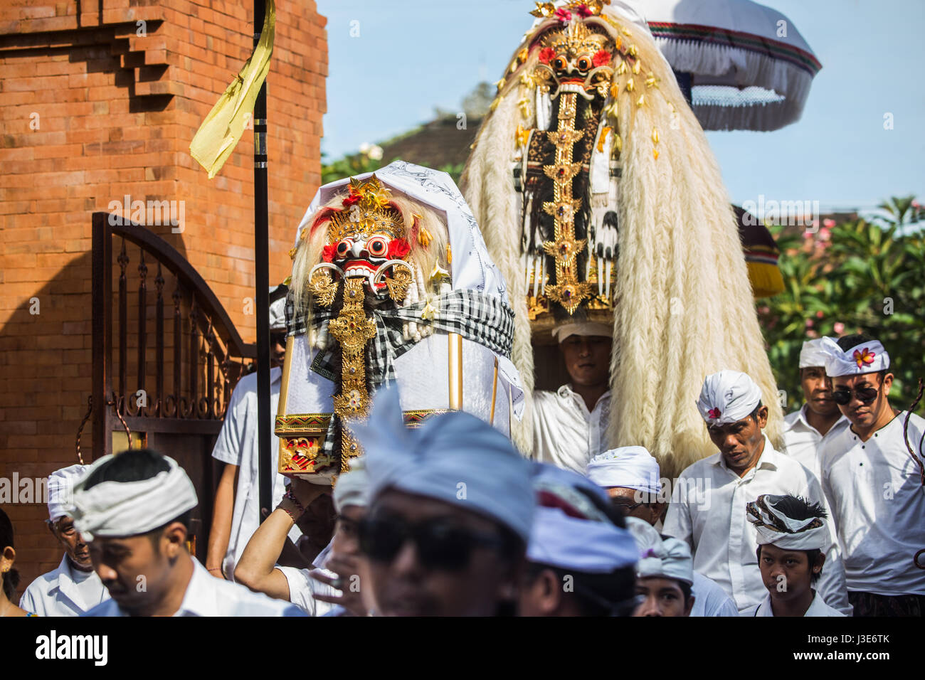 Masked men in scary Rangda costumes the demon queen of the witches are carried into a Bali ceremony surrounded by hordes of Balinese Hindu devotees Stock Photo