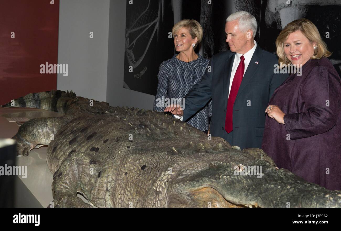 U.S. Vice President Mike Pence, center, reaches out to touch cast of an estuarine crocodile on display at the Australian Museum during a tour with Foreign Minister Julie Bishop, left, and  Museum Director Kim McKay April 22, 2017 in Sydney, Australia. Australia is the final stop in the Vice President four nation trip to Asia. Stock Photo
