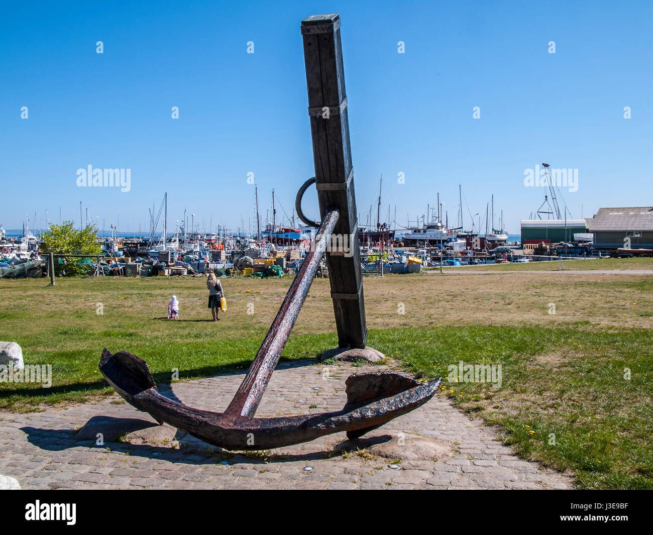 Old recovered anchor of a Danish battleship displayed in the Port of Gilleleje, Denmark. Stock Photo