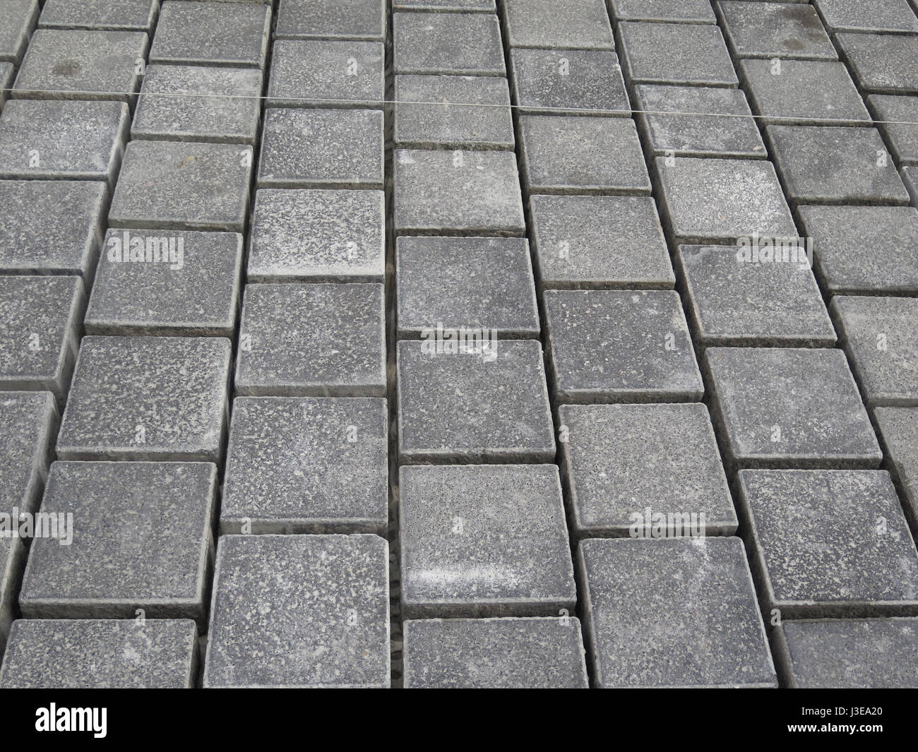 Square paving stones awaiting grouting in village street in Andalusia Stock Photo