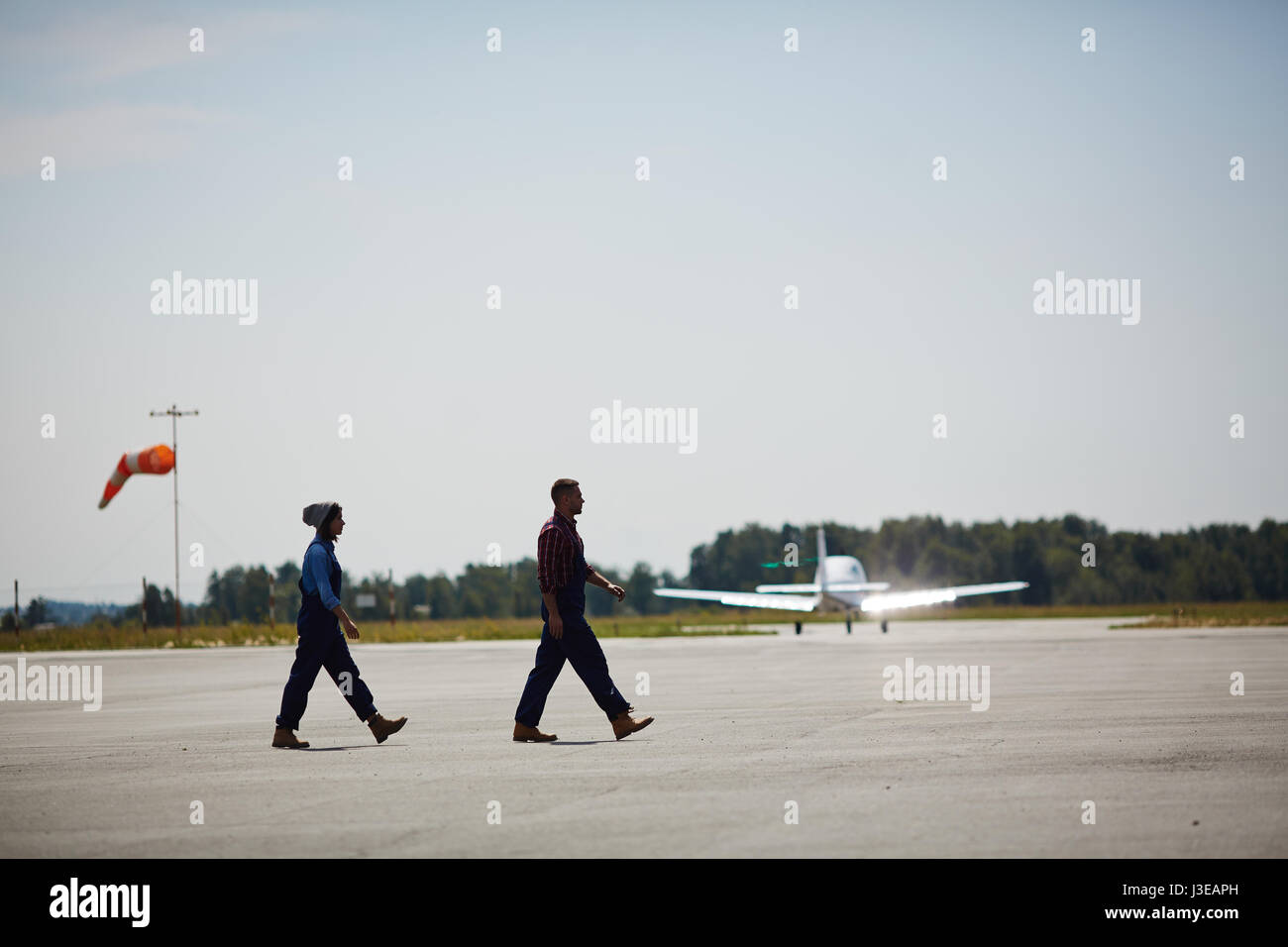Airport Workers on Runway Field Stock Photo
