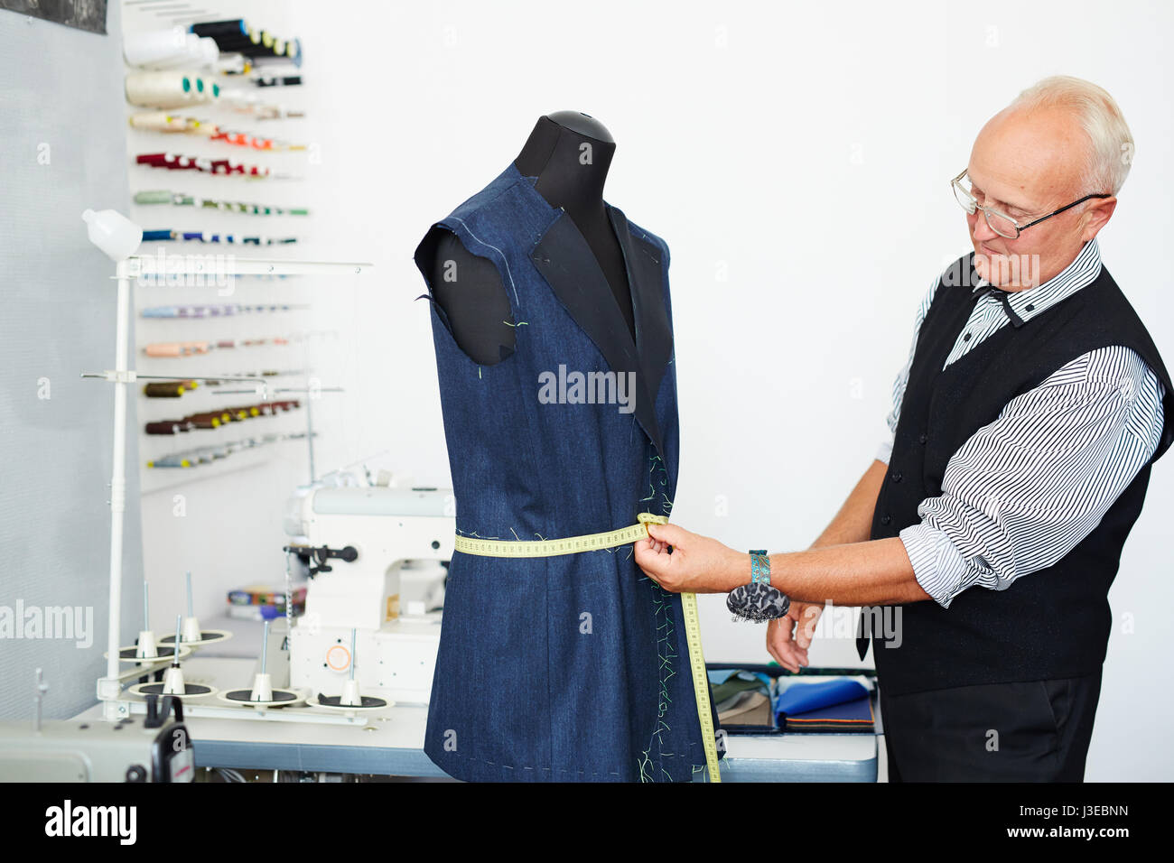 https://c8.alamy.com/comp/J3EBNN/old-tailor-measuring-suit-on-mannequin-J3EBNN.jpg