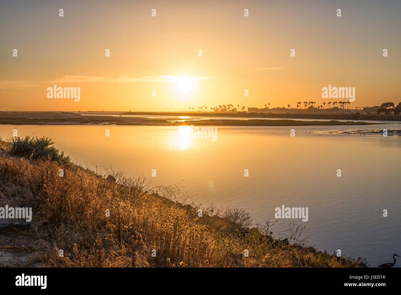 The Sun setting over the San Diego River. San Diego, California, USA. Stock Photo